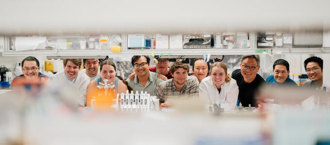 students with faculty in a research lab