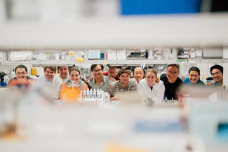 students with faculty in a research lab