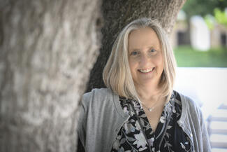 Laura Wuethrich standing in front of a tree